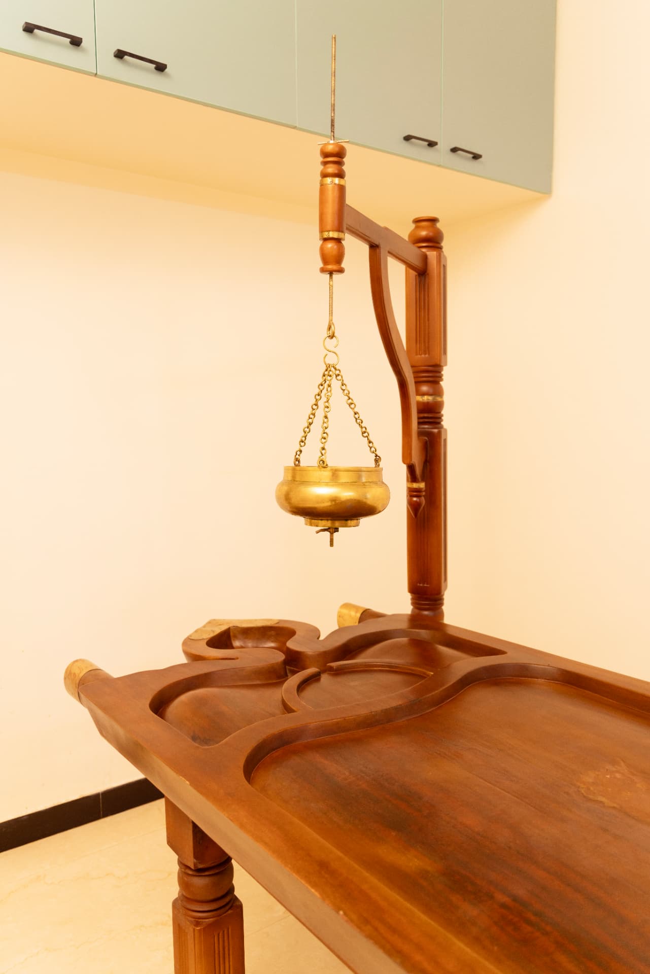 Traditional brass Dhara vessel and treatment table